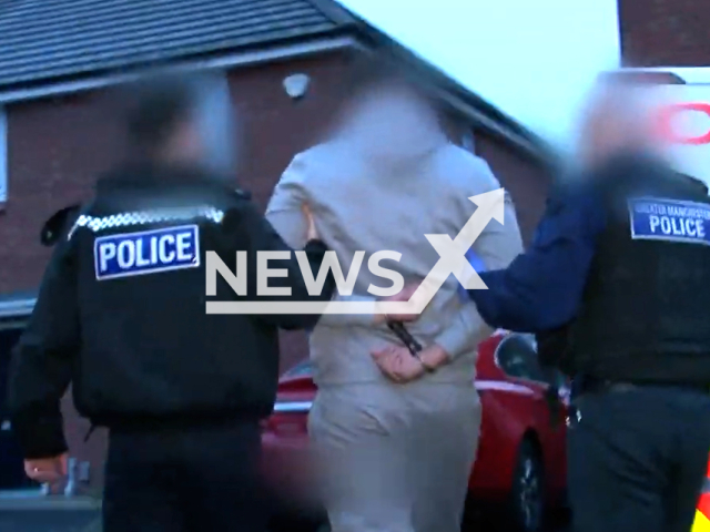 Officers from Wigan’s Challenger team executed two warrants, one on Garvin Jones Grove in Bickershaw, one in Broomfield House in Standish, in England, in undated footage.Note: Picture is screenshot from a video. (@gmpolice/Newsflash)