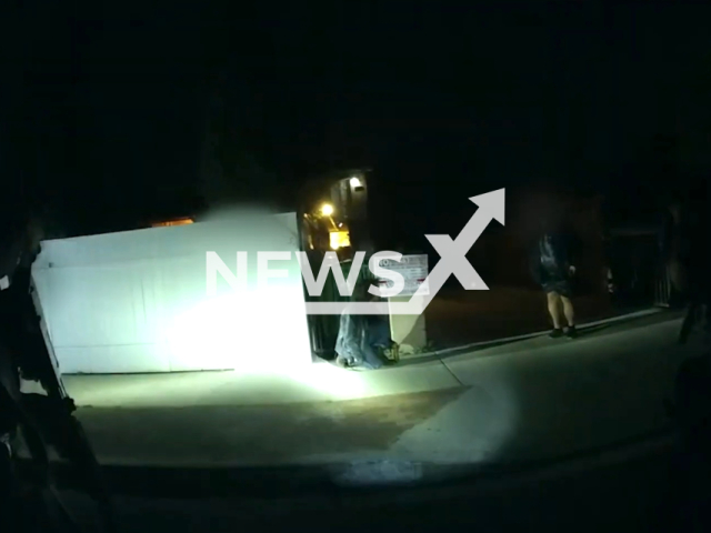 Police officer approaching the suspect in Los Angeles, USA, undated. The suspect was later hit by a police vehicle and subsequently disarmed and taken into custody on the 8th of February 2023. Note: Picture is a screenshot from the video.(Los Angeles Police Department/Newsflash)