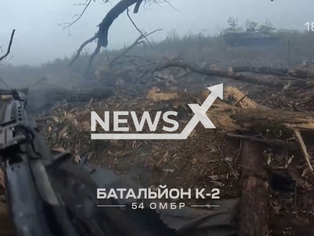 Ukrainian soldier shoots a gun from a trench during "Barracuda" operation near Soledar and Siversk, Donetsk region, Ukraine in undated footage. The footage was released by the K2 combat group of the Ukrainian Ground Forces on Monday, Mar. 13, 2023. Note: Picture is a screenshot from a video (@k_2_54/Newsflash)