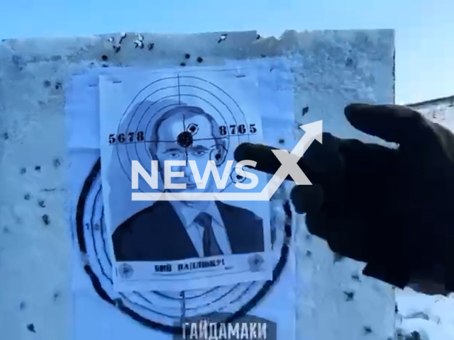 Ukrainian soldier shows middle finger to Putin target in Ukraine in undated footage. The footage was released by the Haidamaky battalion of the Ukrainian Ground Forces on Sunday, Mar. 12, 2023. Note: Picture is screenshot from a video. (@gaidamaky/Newsflash)