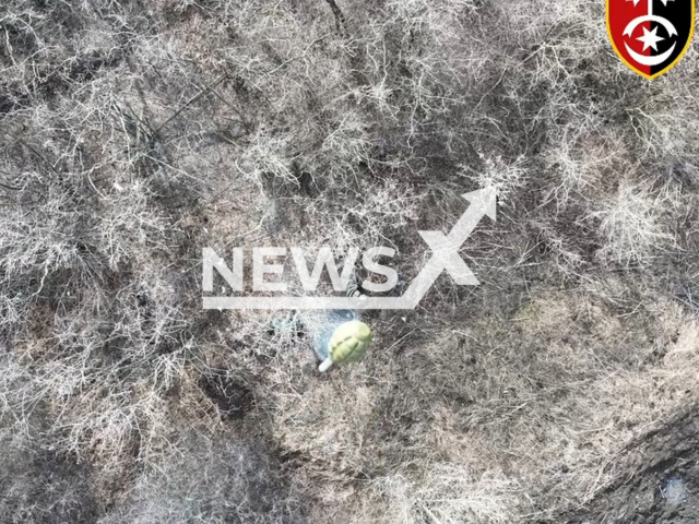 Ukrainian drone bomb falls on Russian positions in Ukraine in undated footage. The footage was released by the 30th brigade of the Ukrainian Ground Forces on Monday, Mar. 13, 2023. Note: Picture is a screenshot from a video (@omb_30/Newsflash)