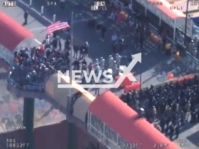 Hundreds of illegal migrants attempt to cross the bridge from Mexico into the United States illegally at the El Paso border on March 12, 2023.  DPS personnel provided assistance to Border Patrol on scene. Note: Picture is screenshot from a video. (Texas Department of Public Safety/Newsflash)