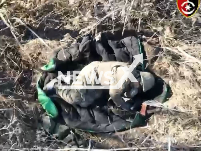 Russian soldier lays on the ground among trees in Ukraine in undated footage. The footage was released by the 30th brigade of the Ukrainian Ground Forces on Tuesday, Mar. 14, 2023. Note: Picture is screenshot from a video. (@omb_30/Newsflash)