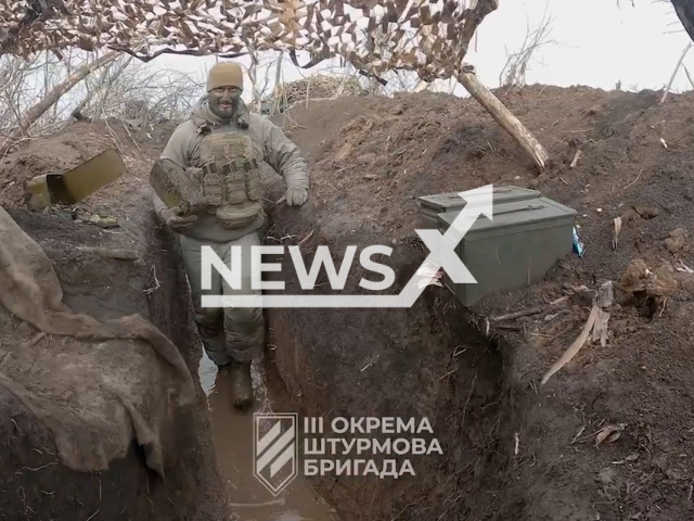 Ukrainian soldier moves in a wet muddy trench at the front on the outskirts of Bakhmut, Donetsk region, Ukraine in undated footage. The footage was released by the 3rd separate assault brigade of the Ukrainian Armed Forces on Thursday, Mar. 16, 2023.Note: Picture is screenshot from a video. (@ab3.army/Newsflash)