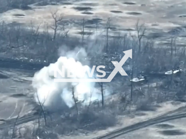 Russian tank explodes among trees in Ukraine in undated footage. The footage was released by the 53rd Brigade of the Ukrainian Ground Forces on Thursday, Mar. 16, 2023.Note: Picture is screenshot from a video. (@53brigade/Newsflash)