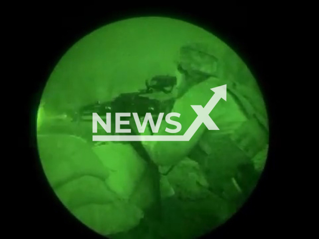 Ukrainian sniper shoots a gun at night in Bakhmut, Donetsk region, Ukraine in undated footage. The footage was released by the the Command of the Ukrainian Special Operations Forces on Friday, Mar. 17, 2023. Note: Picture is a screenshot from a video (@usofcom/Newsflash)