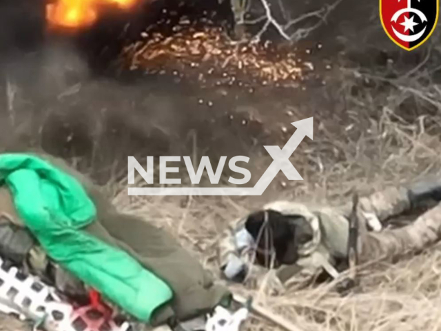 Ukrainian drone bomb explodes near relaxing Russian soldiers under trees in Ukraine in undated footage. The footage was released by the 30th brigade of the Ukrainian Ground Forces on Thursday, Mar. 16, 2023.Note: Picture is screenshot from a video. (@omb_30/Newsflash)