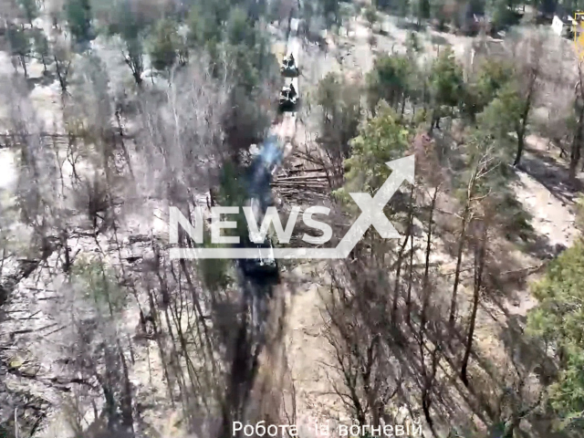 Ukrainian tanks move down the road among trees during combat training in Kyiv region, Ukraine in undated footage. The footage was released by the Ukrainian Ground Forces on Thursday, Mar. 16, 2023. Note: Picture is a screenshot from a video (@UALandForces/Newsflash)