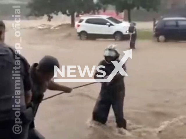 Rescuers rescue people after the rainfall that caused severe flooding in the Avenida Aricanduva and Rio das Pedras areas, located in the eastern part of Sao Paolo, Brazil, on March 8, 2023. Numerous people found themselves stranded due to the rapidly rising waters. Note: The picture is a screenshot from the video. (Military Police of the State of São Paulo/Newsflash)