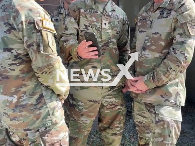 An Army officer talks on the phone with his son who got promoted in the army, undated. Note: The picture is a screenshot from the video. (The U.S. Army/Newsflash)