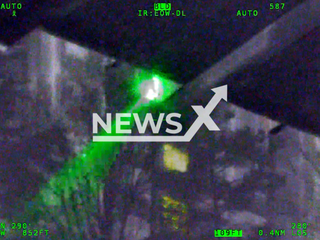 Cameron Van Vleet, 25, points a laser at a police helicopter, in Fairfax County, Virginia, on Friday, Mar. 10, 2023. According to Fairfax County Police Department, the man was arrested and charged with interference with the operation of an aircraft. Note: Picture is screenshot from a video. (Fairfax County Police Department/Newsflash)