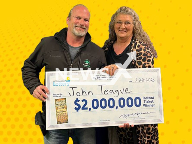 John Teague and his wife pose with lottery check, undated. He won a USD 2 million prize on a USD 20 scratch-off purchase. Note: Licensed photo.  (NC Lottery/Newsflash)