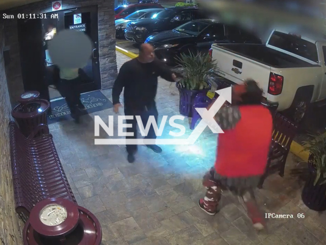 Security guard aims a gun at Michael Rudman, 44, at the entrance of Mons Venus strip club in Tampa, USA on Sunday, Mar. 19, 2023. Police arrested Michael. Note: Picture is a screenshot from a video (@TampaPD/Newsflash)