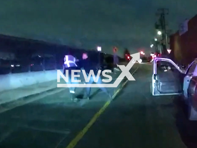 The police officer arrests the suspect after they followed his vehicle in Los Angeles, California, USA on Feb. 13, 2023. The suspect Villalobos was taken into custody with a leg injury and transported to a local hospital for treatment. Note: Picture is screenshot from a video. (Los Angeles Police Department/Newsflash)