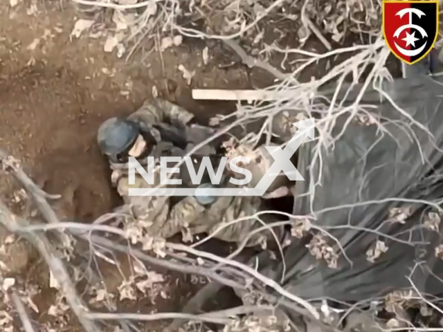 Russian soldiers try to hide in panic while being bombarded by the Ukrainian drone in Ukraine in undated footage. The footage was released by the 30th separate mechanized brigade on Wednesday, Mar. 22, 2023. Note: Picture is a screenshot from a video (@30brigade/Newsflash)