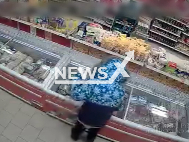 A woman, 30, steals meat from fridge in supermarket in Perm, Russia, undated. The woman lost in the supermarket and was caught by sellers. Note: Picture is screenshot from a video. (Police of Prikamye/Newsflash)