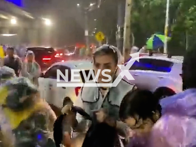 People evacuating the Asuncionico, music festival held in Asuncion, Paraguay, after rain caused flooding on 23rd March. Note: This picture is a screenshot from the video (@gibritos/Newsflash).