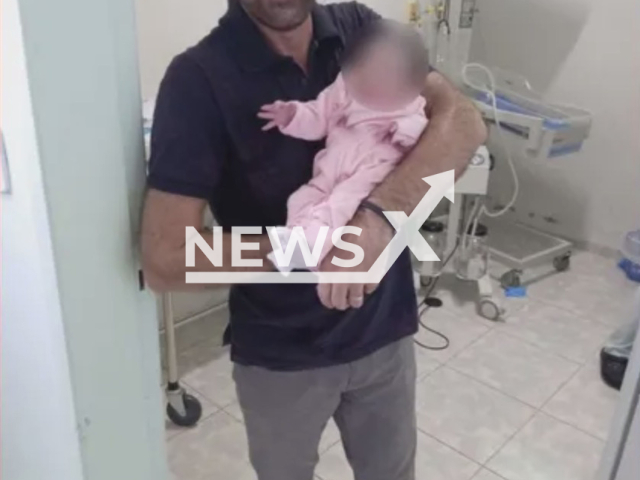 Photo shows Claudio Roberto Lopes Zen, holding a baby, undated. Claudio Roberto Lopes Zen, the director of a school in Ubirata, Parana, Brazil, reportedly helped to student give birth. Note: Picture is private (Claudio Roberto Lopes Zen/Newsflash)