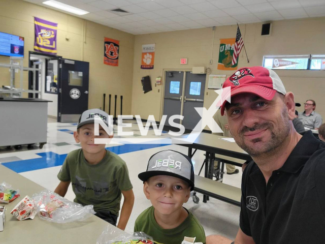 Adem Qorri, 40, poses with his sons in undated photo. He died after saving his friend's son, 6, from drowning in Anclote River Park, Florida, USA. Note: Private photo. (Adem Qorri/Newsflash)