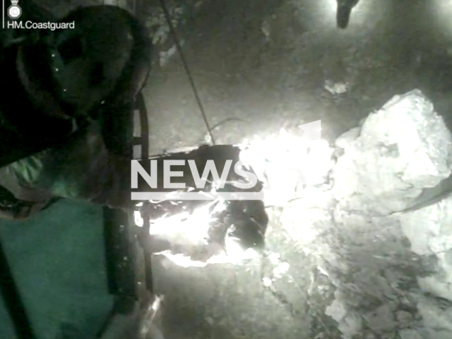 Rescuers rescue man who fell up to eight meters onto a granite slab while climbing with three friends at Trewavas Head in South Cornwall, UK on March 31, 2023. The incident required evacuation by helicopter. Note: Picture is screenshot from a video. (Maritime and Coastguard Agency/Newsflash)