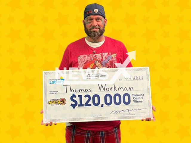 Thomas Workman poses with his lottery winning check, undated.  Almost four years after his father’s death,  he won a USD 120 thousand jackpot  by continuing to play their shared lucky numbers.
Note: Licensed photo.  (NC Lottery/Newsflash)