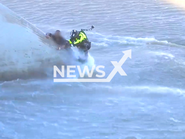 Rescuers rescue a man in Los Angeles, California, USA on March 31, 2023.  The rescue operation was deemed a "full river rescue," indicating that it was a complex and potentially dangerous operation. Note: The picture is a screenshot from a video. (LAFD/Newsflash)