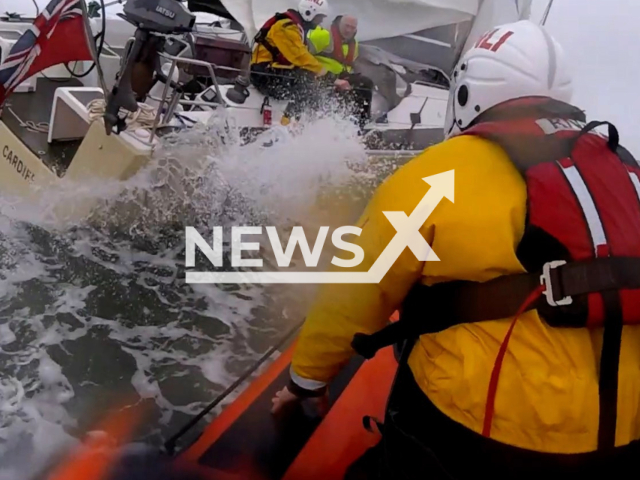 HM Coastguard and RNLI rescue a lone sailor off the north Devon coast, in South West England, on Friday, March 31, 2023. Despite the severe conditions, the crew managed to tow the yacht to calmer waters and complete the rescue. Note: Picture is screenshot from a video. (@MaritimeandCoastguardAgency/Newsflash)