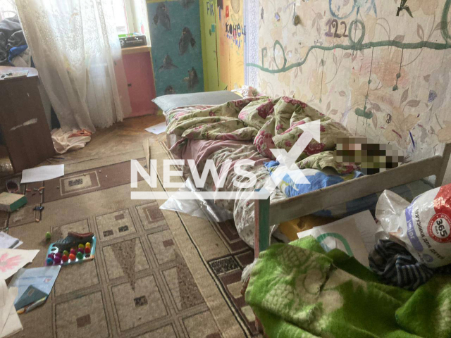 An emaciated boy, 7, lays under blanket in an apartment littered with rubbish in Moscow, Russia, undated. The boy was hospitalized and handed over to the authorities. Note: Picture is from the Prosecutor's Office of Moscow. (@moscowproc/Newsflash)