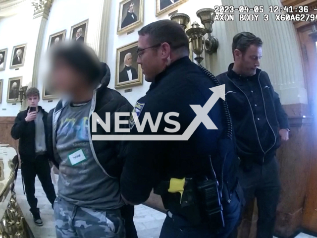 Police officers remove a student from the state Capitol legislative session, in Denver, Colorado, on Wednesday, March 5, 2023. Three students were forcibly removed from the session. Note: Picture is screenshot from a video. (Colorado State Patrol/Newsflash)