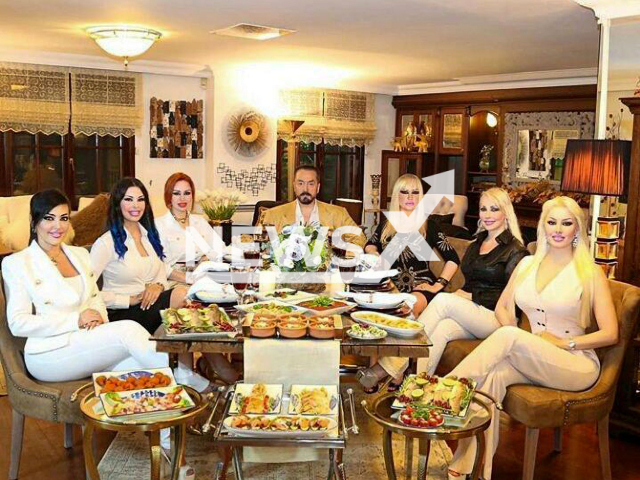 The Turkish televangelist Adnan Oktar, who has been sentenced to 1,075 years in prison for crimes including torture and sexual abuse, pictured with some of his female followers. Note: Private picture (@adnanoktar_/Newsflash)