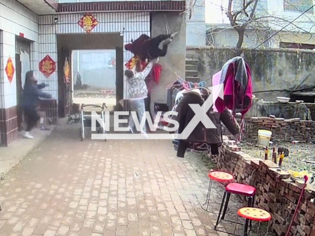 Men catch an OAP with Alzheimer disease who fell from balcony in Fuyang, China. Note: Picture is a screenshot from a video (52206274/AsiaWire)