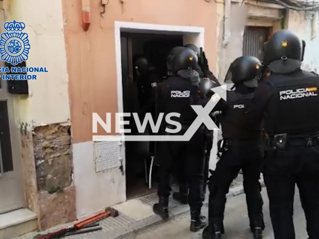 Police raid  the house where  8 victims of sexual exploitation where kept in Valencia, Spain, undated. The women were found through advertisements  offering them financial benefits then having them do  sexual practices imposing economic  sanctions if they refused. Note: Picture is screenshot from a video. (Newsflash)