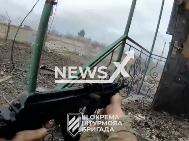 Ukrainian fighter fire from machine gun during street battle in Bakhmut in Ukraine in undated footage. The footage was released by 3rd separate assault brigade on Friday, Apr. 14, 2023. Note: Picture is screenshot from a video. (@ab3.army/Newsflash)