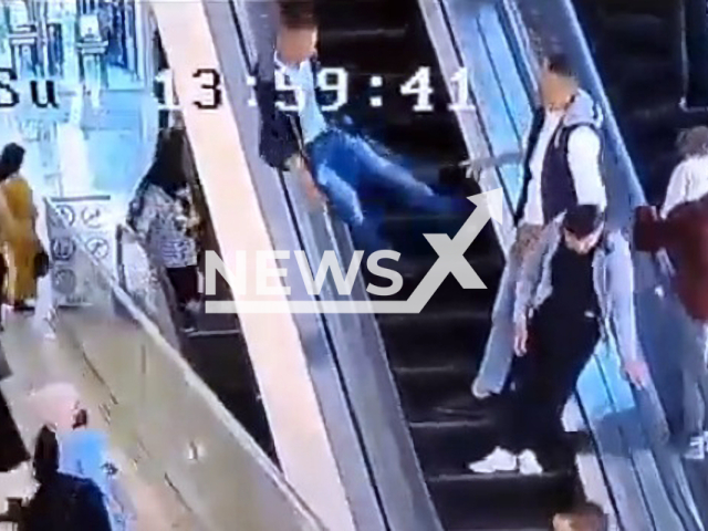 A teenager falls from the escalator in a shopping centre in Irbid, Jordan, on 27th March 2022. Note: Picture is a screenshot from a video (Newsflash)