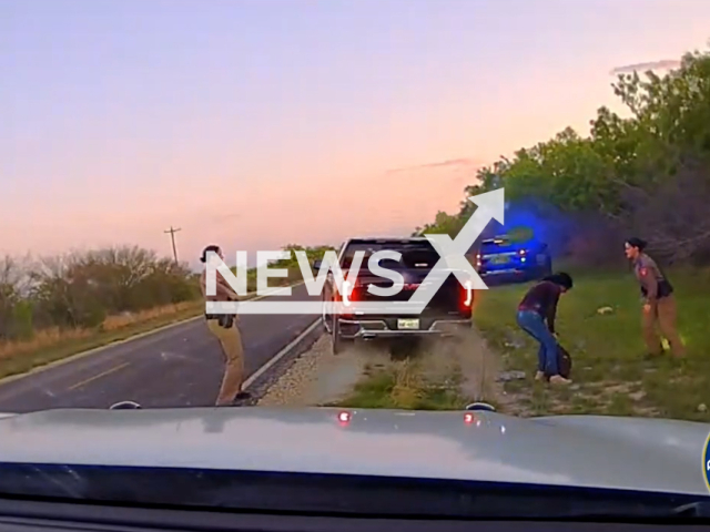 Picture shows DPS Troopers in action in Kinney County, Texas, on Monday, April 10, 2023. The troopers arrested a human smuggler from Gonzalez. Note: Picture is screenshot from a video. (@TxDeptPublicSafety/Newsflash)