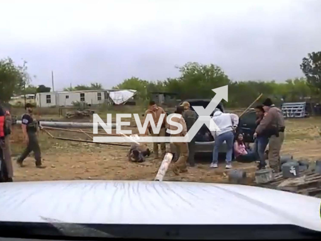 DPS Troopers detain suspects, in Kinney County, Texas, on Friday, April 7, 2023. The troopers arrested Donald Ray Graves and Najoua Jabarie Harris for human smuggling. Note: Picture is screenshot from a video. (@TxDeptPublicSafety/Newsflash)