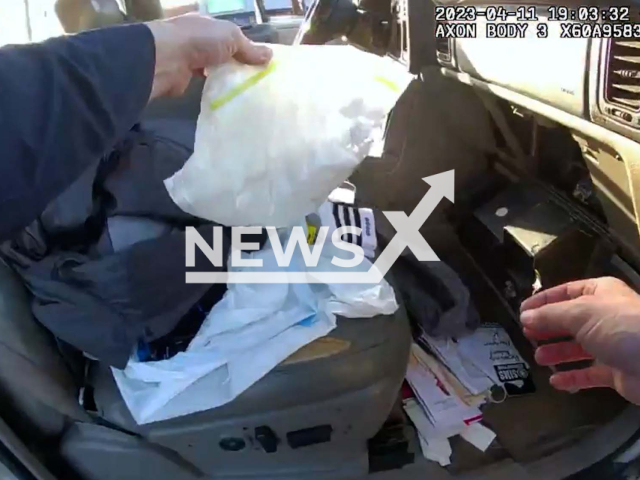 Police officer finds drugs in a convicted felon's SUV, in Atlanta, Georgia, on Tuesday, April 11, 2023. The felon, Craig Benning, 41, was arrested and is charged with operating a vehicle with a suspended registration and trafficking cocaine. Note: Picture is screenshot from a video. (City of Atlanta Police Department/Newsflash)