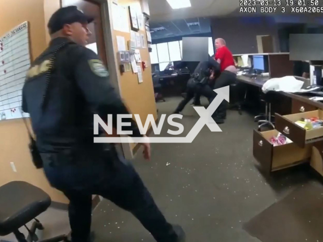 Police officers detain a suspect, in Oklahoma City, Oklahoma, on Monday, March 13, 2023. The suspect was armed with a 3-hole punch. Note: Picture is screenshot from a video. (Oklahoma City Police Department/Newsflash)