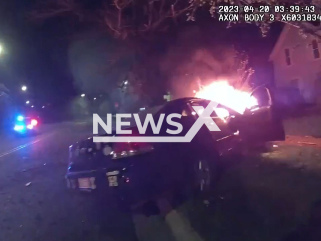 Picture shows a burning car in Lansing, Michigan, on Thursday, April 20, 2023. Police officer, William Tervo, rescued several victims from the burning car. Note: Picture is screenshot from a video. (Lansing Police Department/Newsflash)