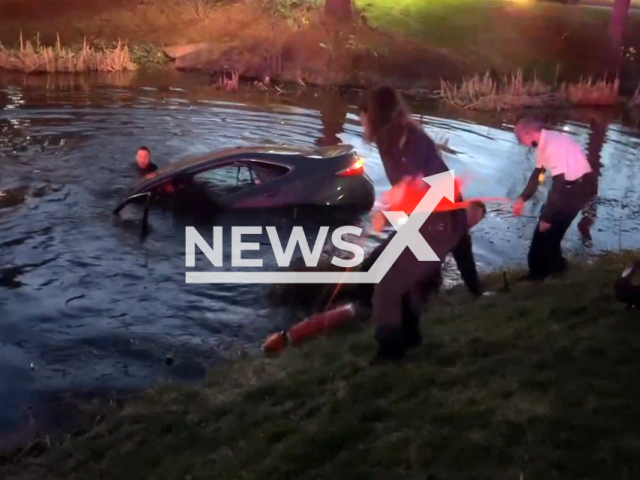 Officers rescue two people from a submerged car, in Pequannock Township, New Jersey, on Sunday, April 2, 2023. Sgt. Dericks, Ptl. Parigi and Ptl. Knatz arrived on the scene and were able to remove the passenger and driver to safety. Note: Picture is a screenshot from a video (Pequannock Township Police/Newsflash)