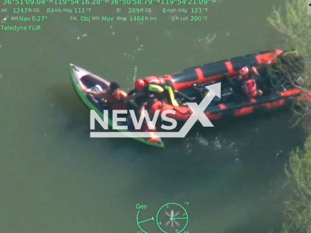 Firefighters rescue two people and a dog who were in an inflatable kayak on the San Joaquin River, in Fresno County, California, on Thursday, April 20, 2023. Note: Picture is a screenshot from a video (@FresnoSheriffsOffice/Newsflash)