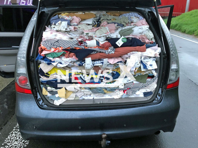 Image shows the car trunk stuffed with stolen clothes, undated photo. The items worth more than EUR 10,000 (GBP 8,858) were seized near the town of Erkrath, in North Rhine-Westphalia State, Germany, on Saturday, April 22, 2023. Note: Licensed content. (Mettmann Police/Newsflash)