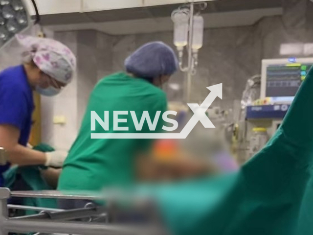 Picture shows doctors delivering a baby in an operating room in a hospital in Belgrade, Serbia, in undated footage. A nurse broadcasted the birth live. Note: Picture is a screenshot from a video. (Newsflash)