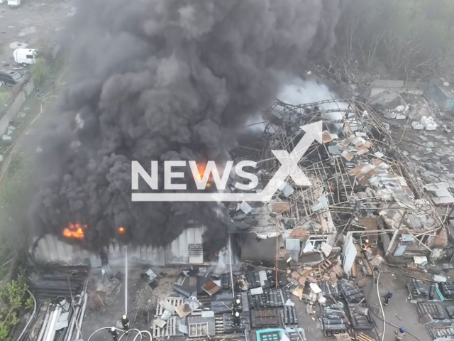 Security workers eliminates the consequences of the Russian missile attacks in Dnipro in Ukraine on Friday, Apr. 2023. One of the missiles hit a hangar with construction materials, causing a fire on an area of 400 square meters. 
Note: Picture is a screenshot from a video (@dsns_telegram/Newsflash)