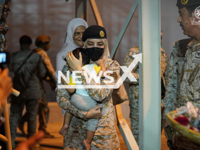 A Saudi female soldier carries a toddler to safety in Jeddah, Saudi Arabia, undated. The boy was falling asleep in her arms. Note: Photo of the Saudi Ministry of Defense. (Saudi Ministry of Defense/Newsflash)