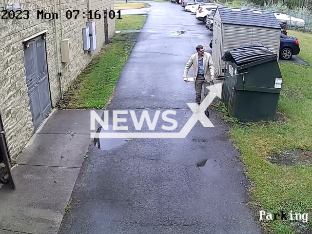 School Principal James Marsh is surprised when a black bear pokes its head out of the dumpster, in Nicholas County, West Virginia, USA, on Monday, May 1, 2023. Principal   Marsh  ran and the bear ran in the opposite direction, no one was hurt.  Note: Picture is a screenshot from a video (Nicholas County Board of Education/Newsflash)