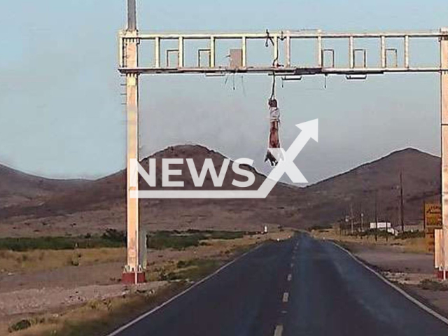 Picture shows the body of a man  hanging from an arch on the highway, in the municipality of Casas Grandes, Mexico, on Tuesday, May 2,  2023. Police found a   message indicating that it done because he was  a rapist. 

 Note: Private photo.  (Newsflash)