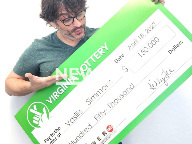 Vasilis Simmons poses with his lottery  check, undated. He forgot that he had bought a Powerball ticket until it fall out of his wallet. Note: Licensed photo.  (Virginia Lottery/Newsflash)