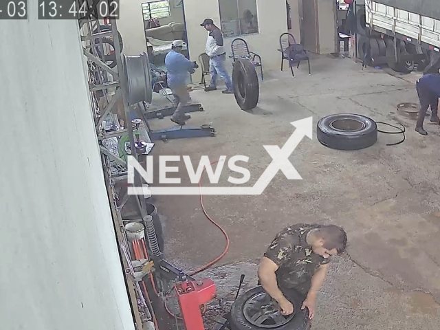 Vinicius Saldanha do Carmo, 29, working on a truck before it's tire exploded in Santiago, Brazil, on Wednesday, May 3, 2023. He had only had been working at the rubber shop for about two weeks. Note: Picture is a screenshot from a video (Newsflash)