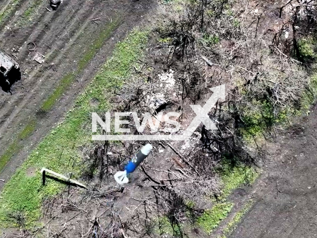 Ukrainian drones drop bombs on hidden Russian soldiers on the frontlines in Ukraine in undated footage. The footage was released by Combined Tactical Group "Adam" on Monday, May. 8, 2023. Note: Picture is screenshot from a video. (@Adamtactic/Newsflash)